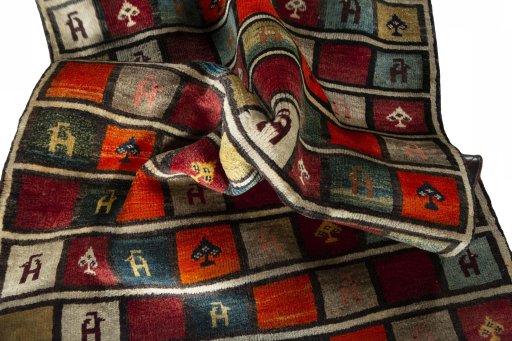 Corner detail of 2000s Persian Gabbeh rug showing border pattern and Wool pile