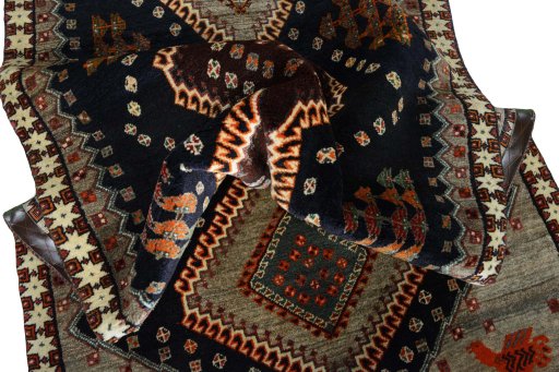 Corner detail of 2000s Persian Gabbeh rug showing border pattern and Wool pile