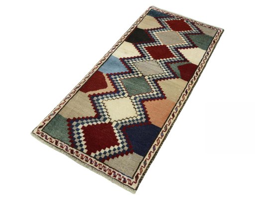 Corner detail of 2000s Persian Gabbeh rug showing border pattern and Wool pile
