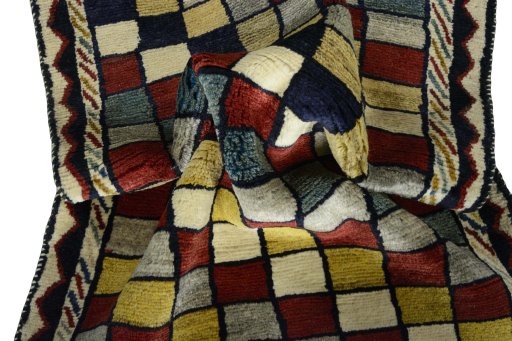 Corner detail of 2000s Persian Gabbeh rug showing border pattern and Wool pile