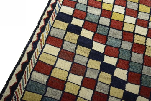 Backside of handmade 2000s Persian Gabbeh rug showing knot structure and weave density