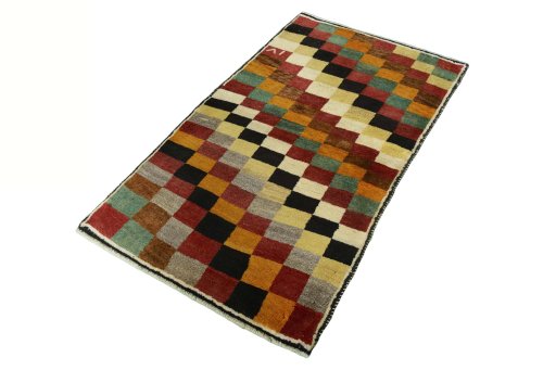 Corner detail of 2000s Persian Gabbeh rug showing border pattern and Wool pile