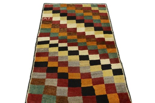Surface texture of 2000s Persian Gabbeh rug with natural Wool and intricate pattern