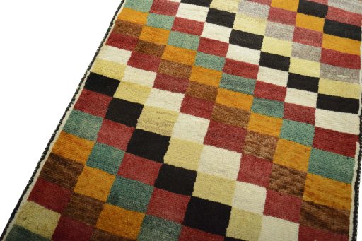 Backside of handmade 2000s Persian Gabbeh rug showing knot structure and weave density