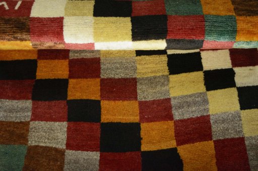Full view of 2000s Persian Gabbeh rug from Iran / Persia, 143 × 82 cm in Multi Color tones