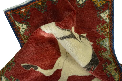 Corner detail of 2000s Persian Gabbeh rug showing border pattern and Wool pile