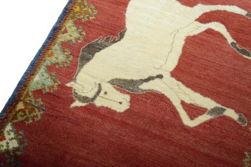 Backside of handmade 2000s Persian Gabbeh rug showing knot structure and weave density
