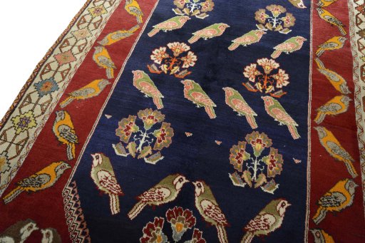 Backside of handmade 2000s Persian Gabbeh rug showing knot structure and weave density