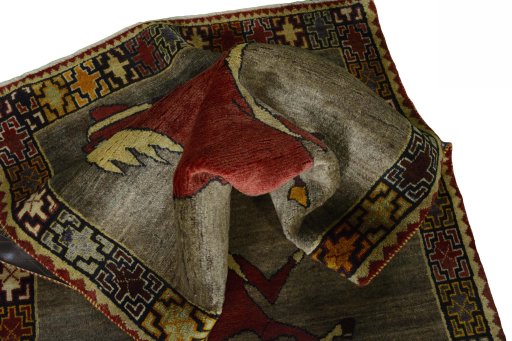 Corner detail of 2000s Persian Gabbeh rug showing border pattern and Wool pile