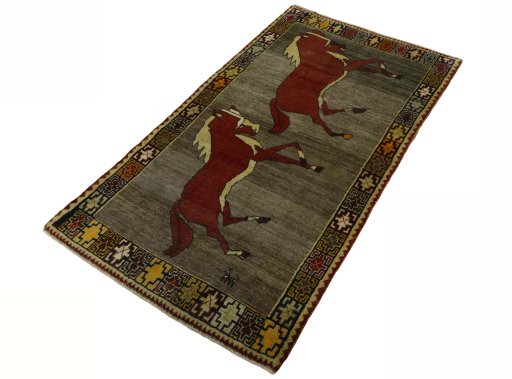 Corner detail of 2000s Persian Gabbeh rug showing border pattern and Wool pile