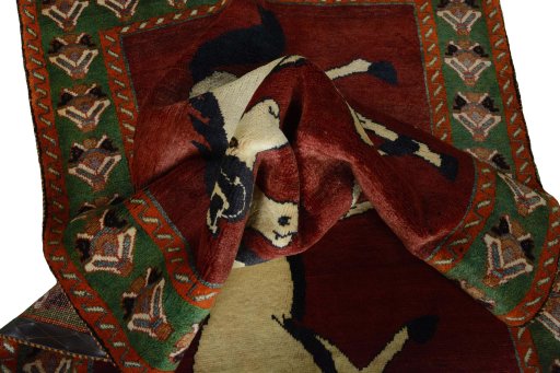 Corner detail of 2000s Persian Gabbeh rug showing border pattern and Wool pile