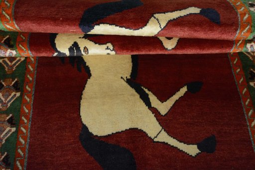 Full view of 2000s Persian Gabbeh rug from Iran / Persia, 245 × 135 cm in Red tones