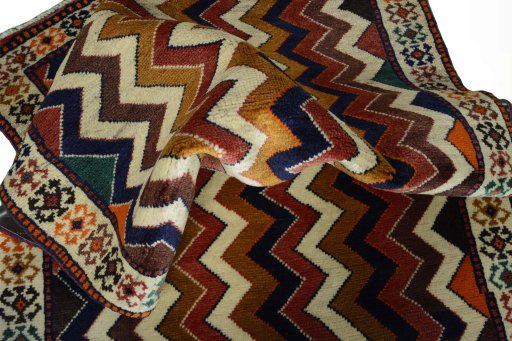 Corner detail of 2000s Persian Gabbeh rug showing border pattern and Wool pile