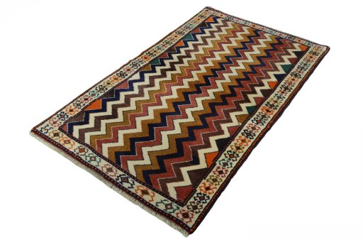 Corner detail of 2000s Persian Gabbeh rug showing border pattern and Wool pile