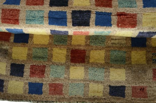 Full view of 2000s Persian Gabbeh rug from Iran / Persia, 104 × 67 cm in Multi Color tones