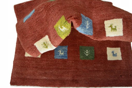 Corner detail of New Persian Gabbeh rug showing border pattern and Wool pile