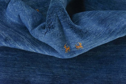 Corner detail of New Persian Gabbeh rug showing border pattern and Wool pile