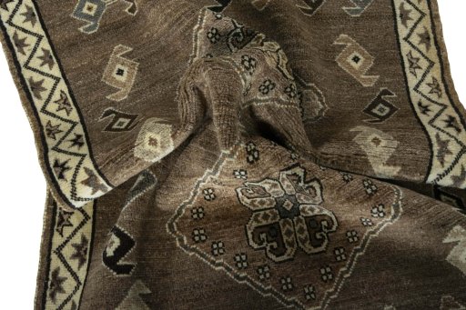 Corner detail of 2000s Persian Gabbeh rug showing border pattern and Wool pile