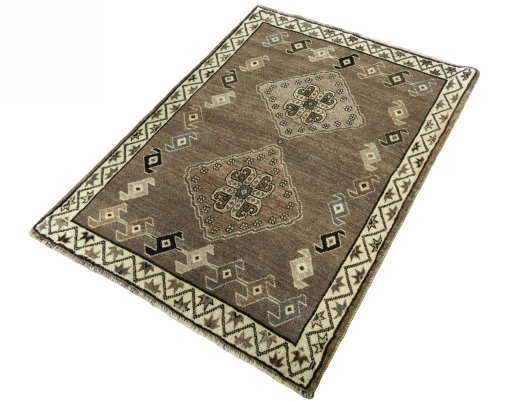 Corner detail of 2000s Persian Gabbeh rug showing border pattern and Wool pile