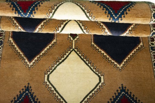 Full view of 2000s Persian Gabbeh rug from Iran / Persia, 170 × 100 cm in Beige tones