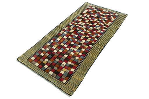 Corner detail of 2000s Persian Gabbeh rug showing border pattern and Wool pile
