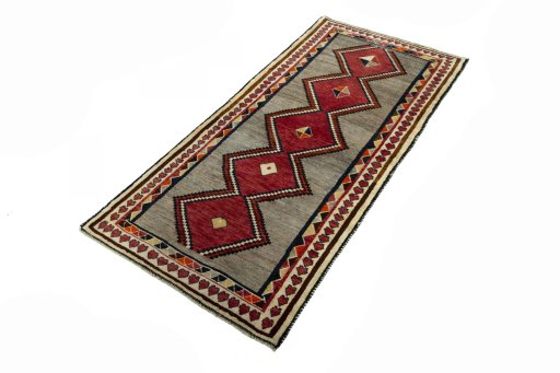 Corner detail of 2000s Persian Gabbeh rug showing border pattern and Wool pile