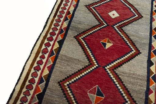 Backside of handmade 2000s Persian Gabbeh rug showing knot structure and weave density