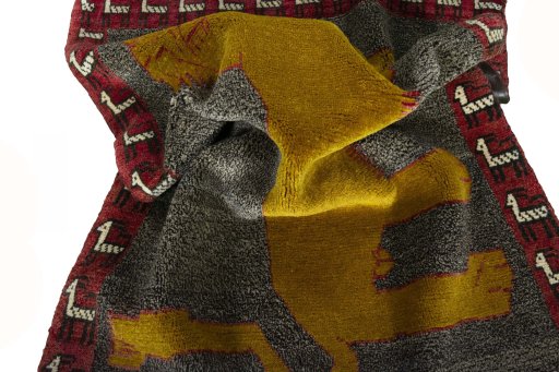 Corner detail of 2000s Persian Gabbeh rug showing border pattern and Wool pile