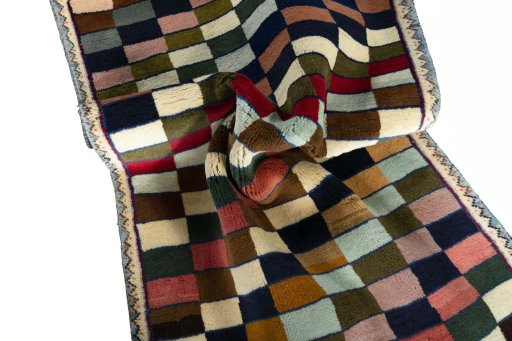 Corner detail of 2000s Persian Gabbeh rug showing border pattern and Wool pile