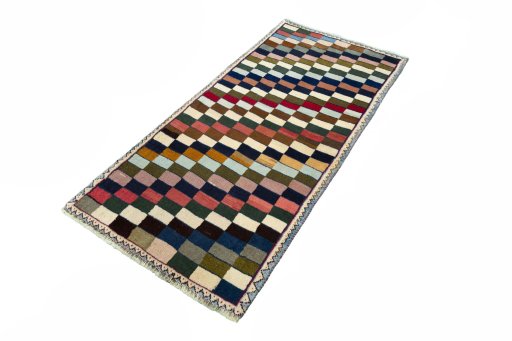 Corner detail of 2000s Persian Gabbeh rug showing border pattern and Wool pile