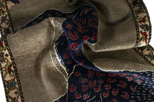 Corner detail of 2000s Persian Gabbeh rug showing border pattern and Wool pile