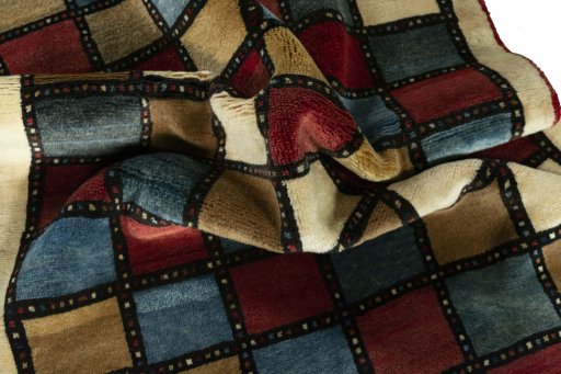 Corner detail of 2000s Persian Gabbeh rug showing border pattern and Wool pile