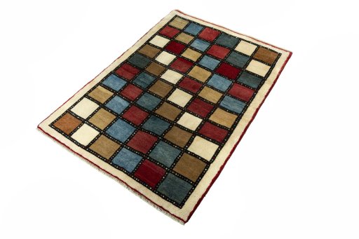 Corner detail of 2000s Persian Gabbeh rug showing border pattern and Wool pile