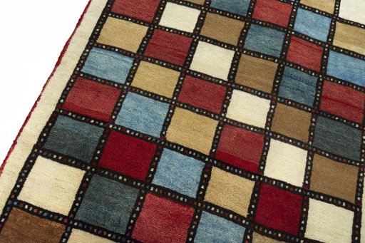 Backside of handmade 2000s Persian Gabbeh rug showing knot structure and weave density