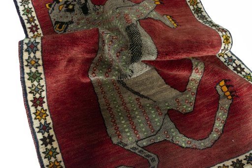 Corner detail of 2000s Persian Gabbeh rug showing border pattern and Wool pile