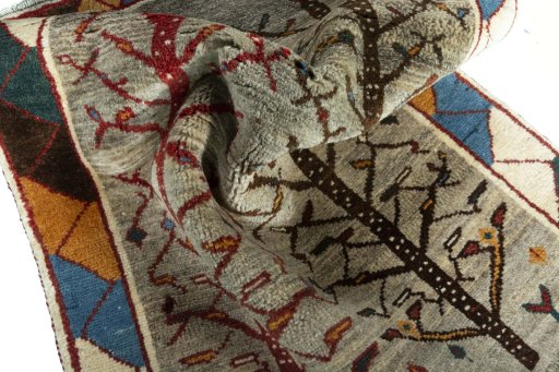 Corner detail of 2000s Persian Gabbeh rug showing border pattern and Wool pile