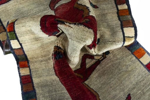 Corner detail of 2000s Persian Gabbeh rug showing border pattern and Wool pile