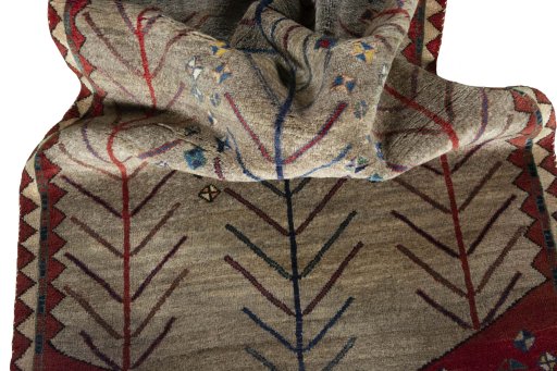 Corner detail of 2000s Persian Gabbeh rug showing border pattern and Wool pile
