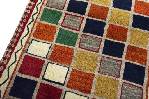 Backside of handmade 2000s Persian Gabbeh rug showing knot structure and weave density