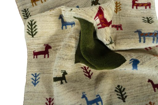 Corner detail of 2000s Persian Gabbeh rug showing border pattern and Wool pile