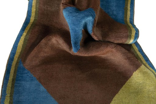 Corner detail of 2000s Persian Gabbeh rug showing border pattern and Wool pile