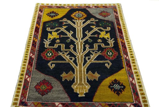 Surface texture of 2000s Persian Gabbeh rug with natural Wool and intricate pattern