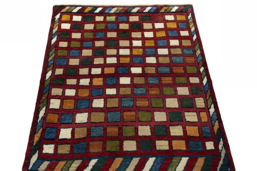 Surface texture of 2000s Persian Gabbeh rug with natural Wool and intricate pattern