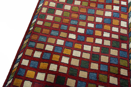Backside of handmade 2000s Persian Gabbeh rug showing knot structure and weave density