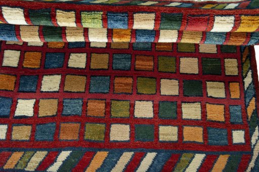 Full view of 2000s Persian Gabbeh rug from Iran / Persia, 132 × 105 cm in Red tones