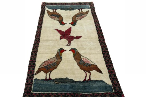 Surface texture of 2000s Persian Gabbeh rug with natural Wool and intricate pattern