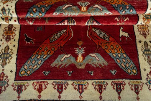 Full view of 2000s Persian Gabbeh rug from Iran / Persia, 222 × 132 cm in Red tones