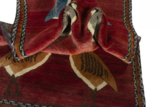 Corner detail of 2000s Persian Gabbeh rug showing border pattern and Wool pile