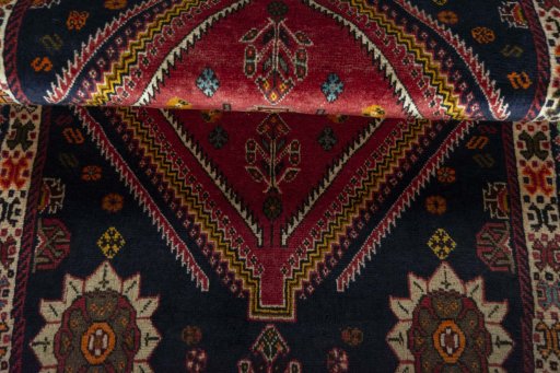 Corner detail of 2000s Persian Gabbeh rug showing border pattern and Wool pile