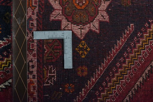 Surface texture of 2000s Persian Gabbeh rug with natural Wool and intricate pattern